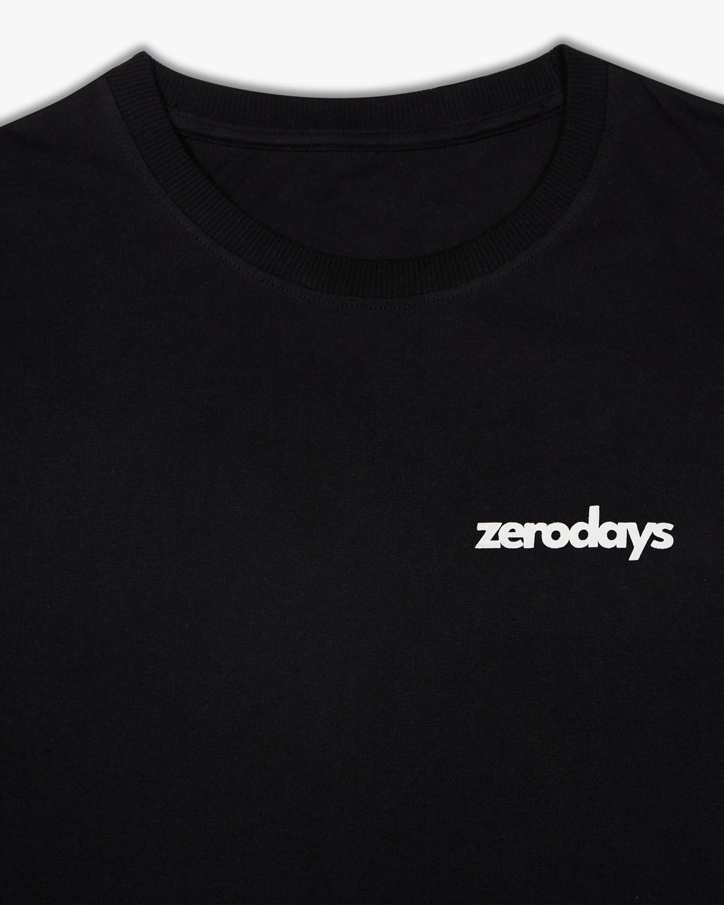 Closeup image of the black basic Zerodays  t-shirt featuring the white brand logo against the black fabric of the t-shirt