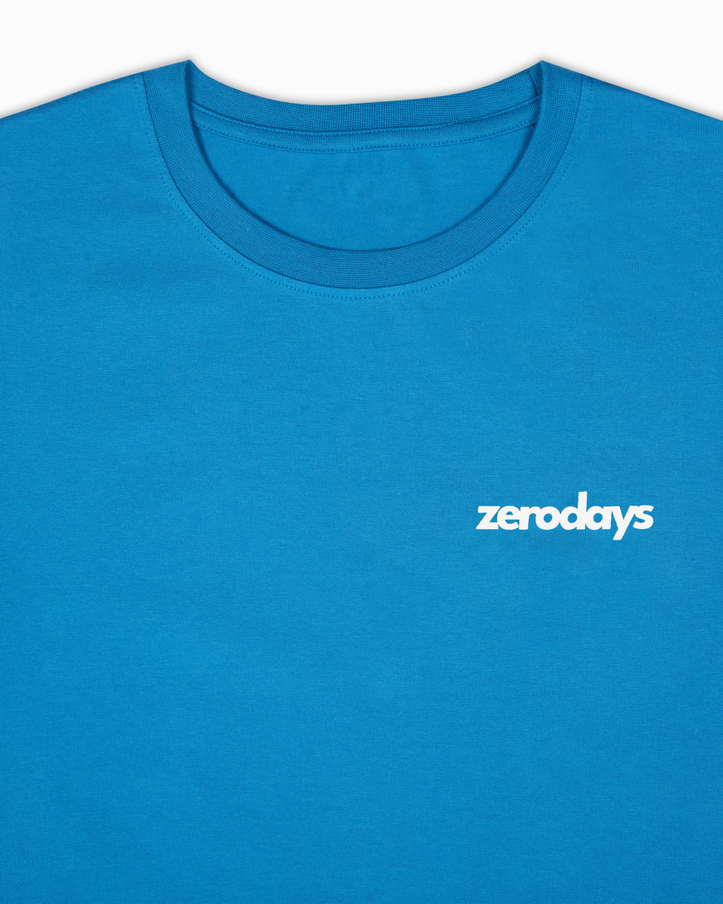 Closeup of the blue basic Zerodays t-shirt showcasing the white Zerodays Logo against the blue fabric of the t-shirt