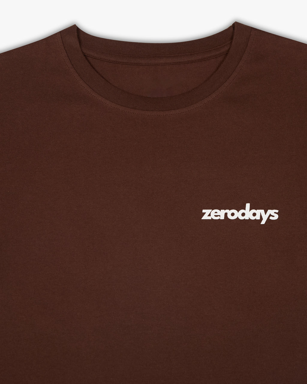 The closeup of the brown basic Zerodays t-shirt with a highlight of the zerodays logo motif on the front of the t-shirt