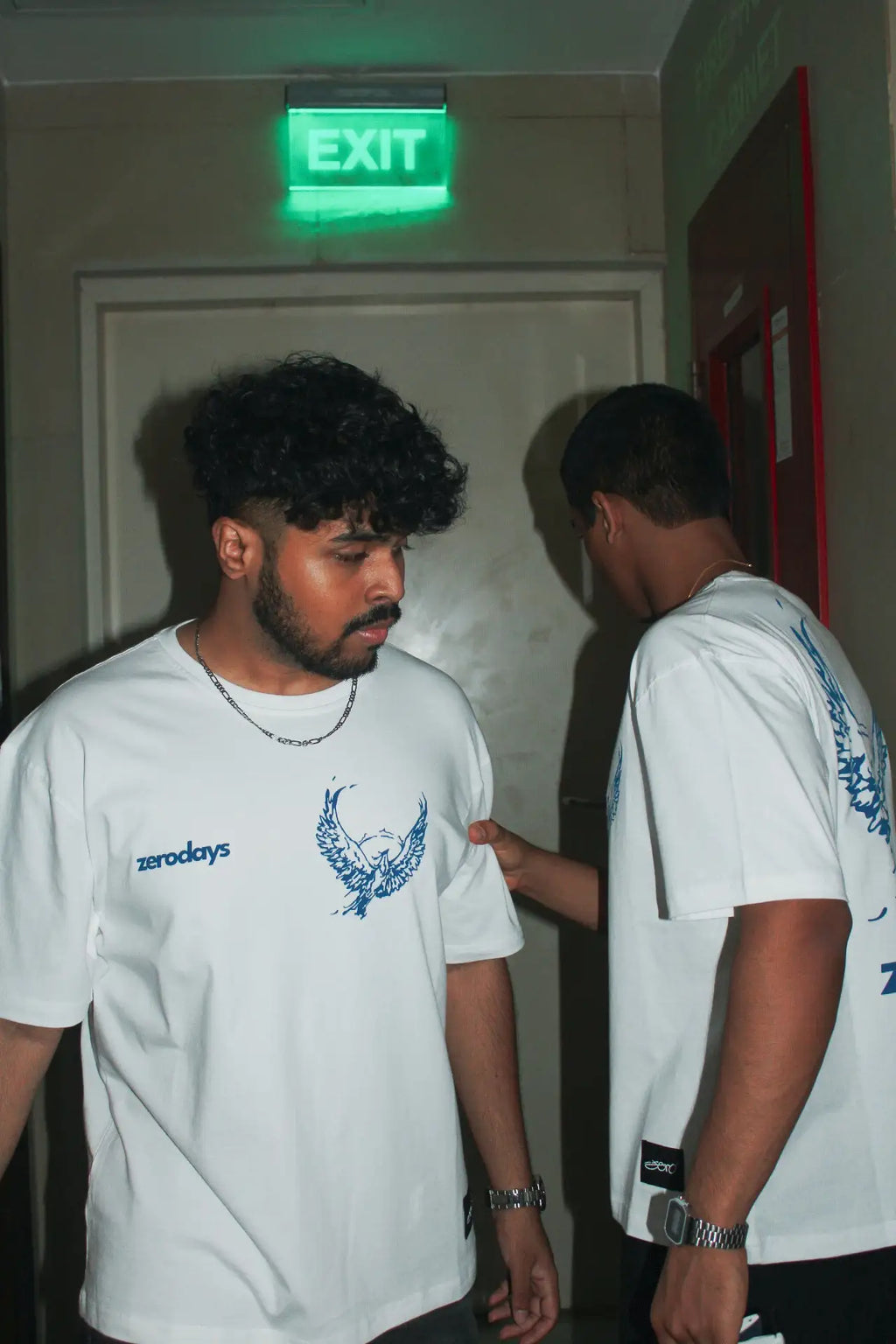 Artistic shot of two boys wearing the 'Phoenix White Tee' from Collection Zero by Zerodays. 