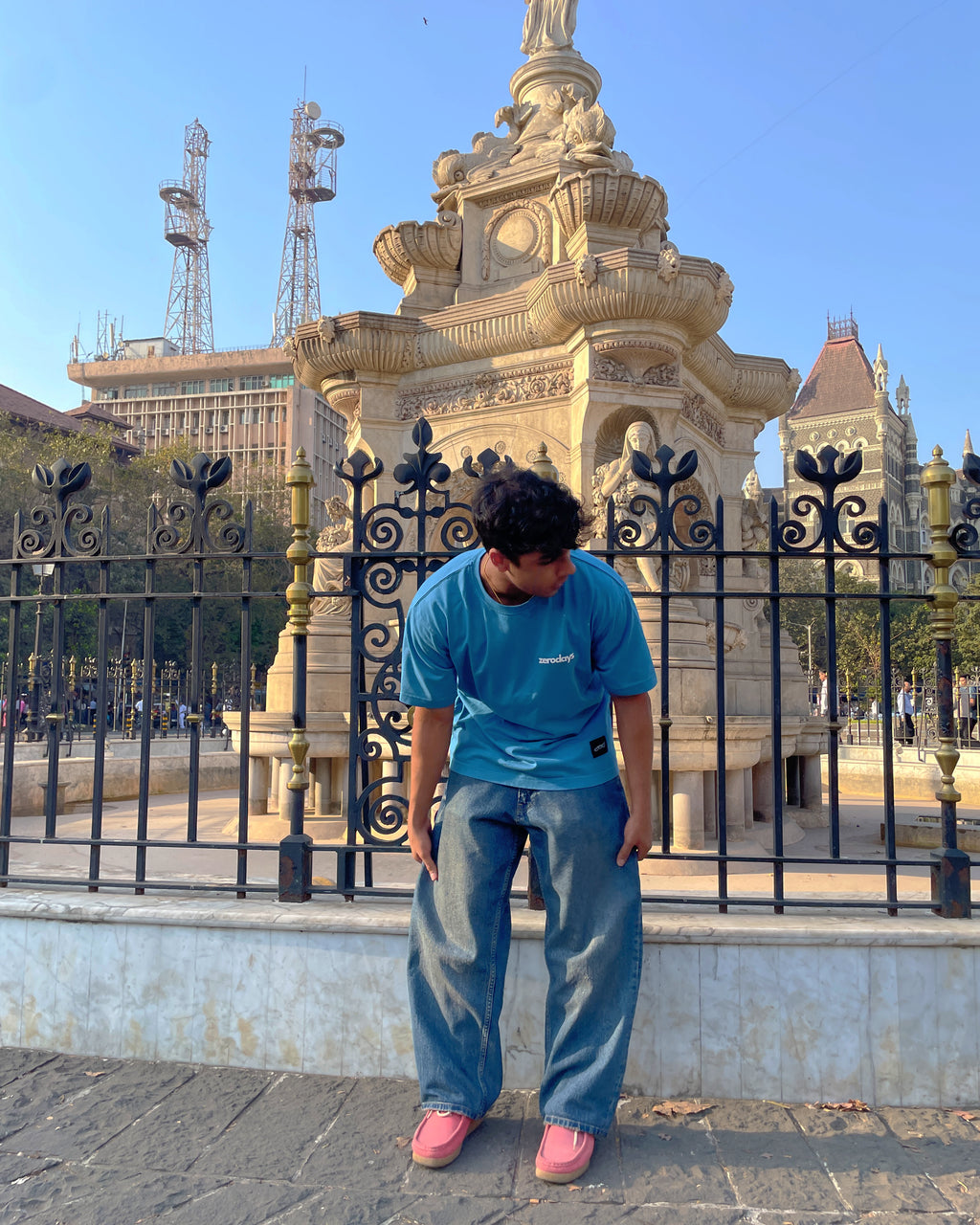 A stylised image of the blue zerodays tshirt against an aesthetic city background. 