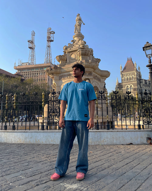 A stylised image of the Blue Zerodays Basics against an artistic background. Worn and styled by the co-founder of the brand. 