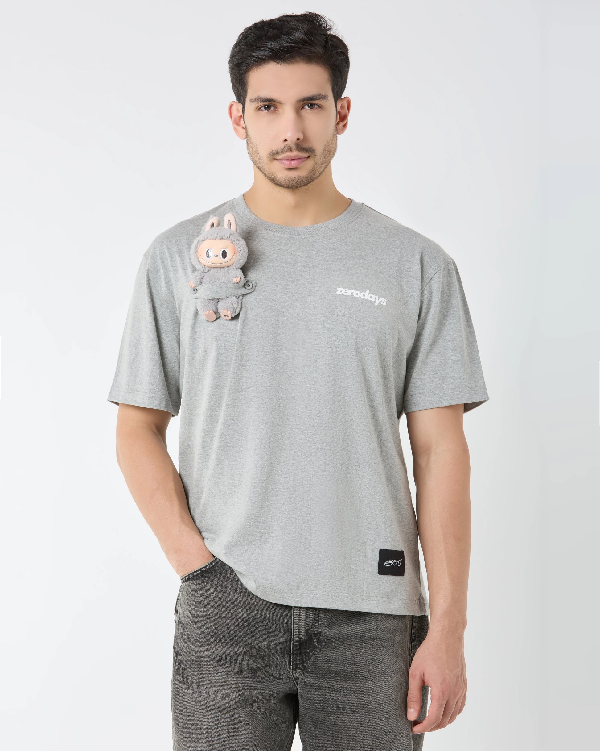 Man wearing a gray t-shirt with a cartoon character and text on a white background