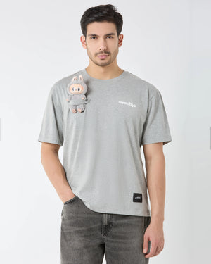 Man wearing a gray t-shirt with a cartoon character and text on a white background