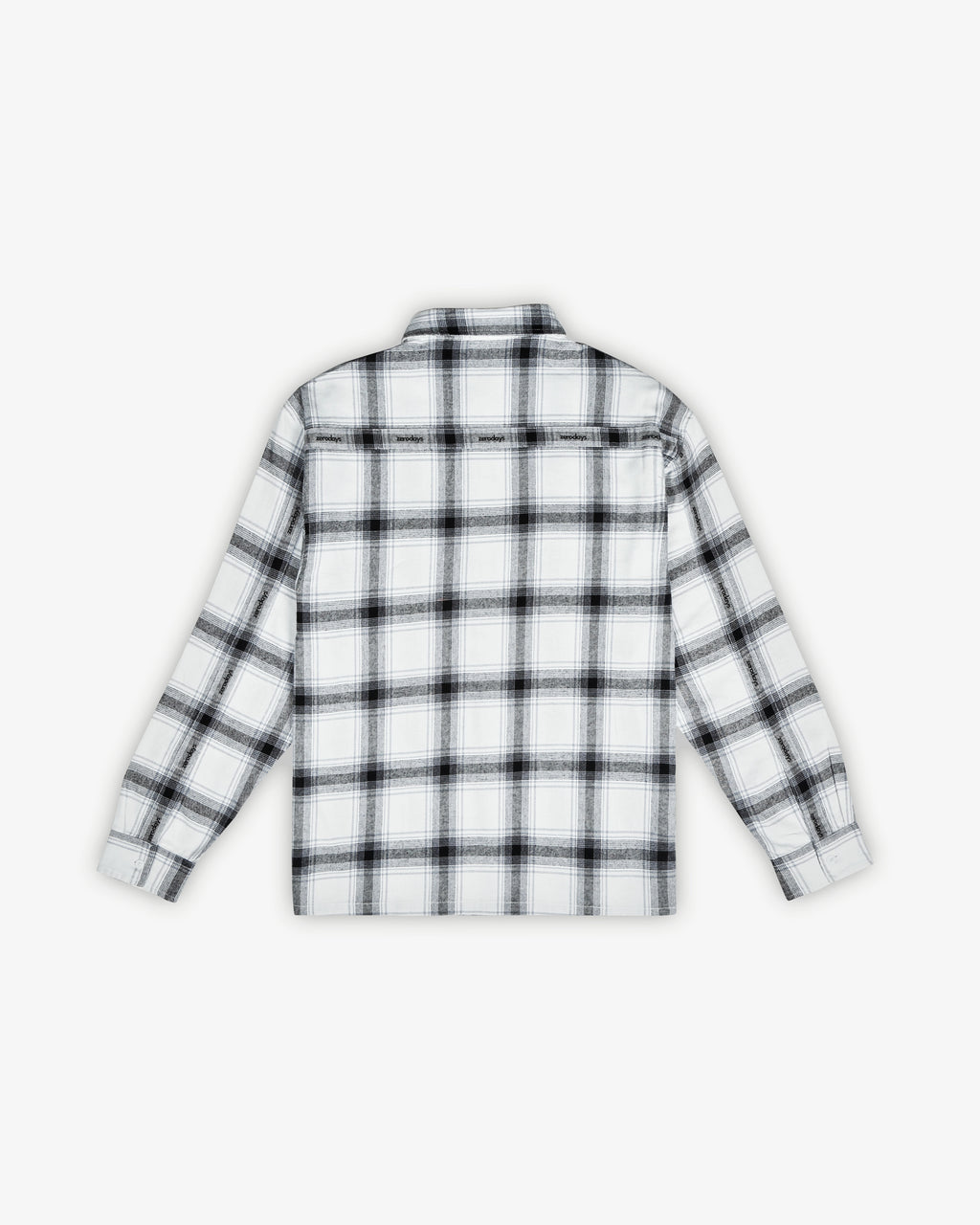 A back flat shot of the Zerodays white essential flannel featuring subtle branding and giving an overview of the shirt's fit. 