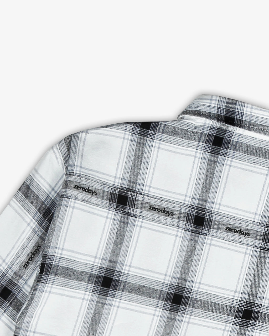 A close up shot of the the back of the Zerodays white essential flannel giving a detailed look on the arc subtle branding on the back and the sleeves of the shirt.